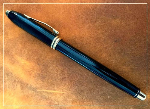 Blue fountain pen on a leather background